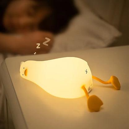 Tired lying duck nightlight also doubles as cellphone stand