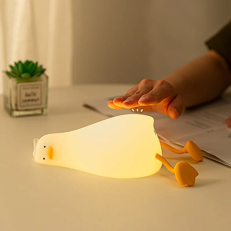 Tired lying duck nightlight also doubles as cellphone stand