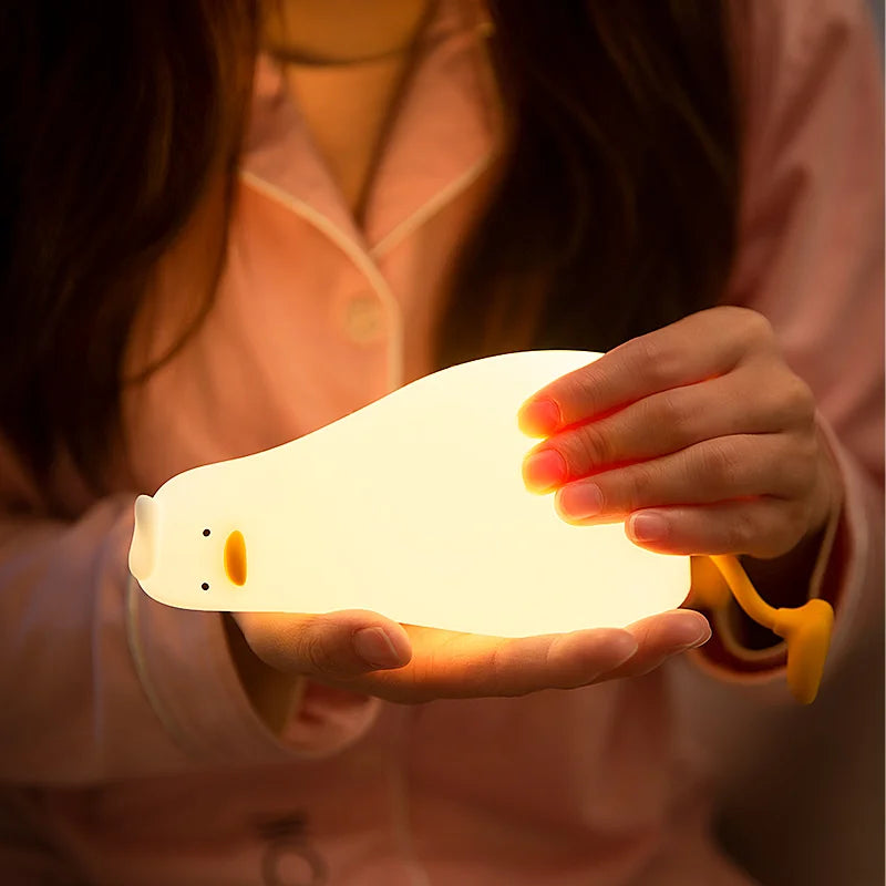 Tired lying duck nightlight also doubles as cellphone stand