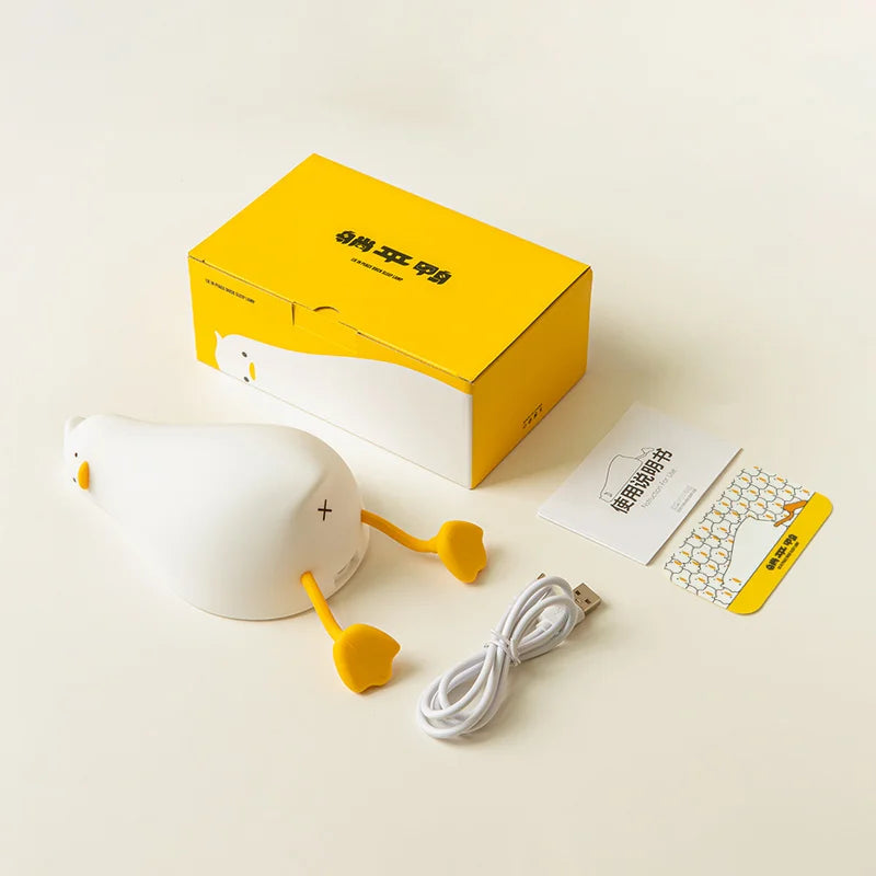 Tired lying duck nightlight also doubles as cellphone stand